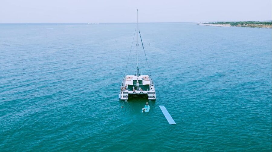 Cadiz capital:Catamarán Experience paseo con baño y almuerzo - The 1-hour swim stop: mats, floats, water slide, and smart rules