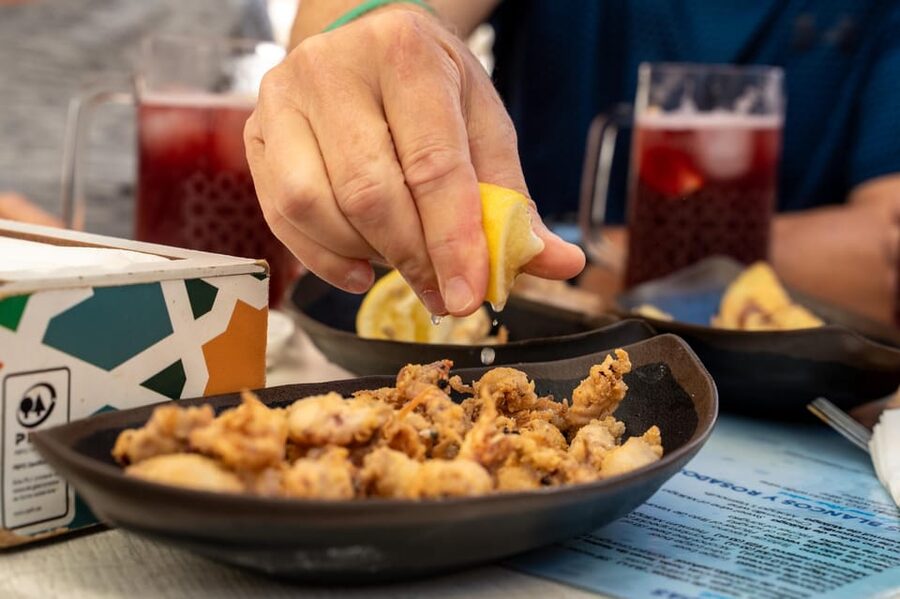 Seville Adventure: Historic Walking Tour & Traditional Tapas - Puerta del Perdón and Alcaicería de la Seda: markets and everyday life