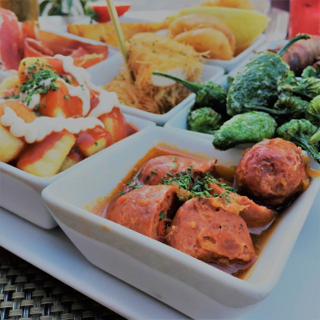 Seville: Tapas and Flamenco Experience - The tapas route in Triana: 4 stops, 4 tapas, 3 drinks